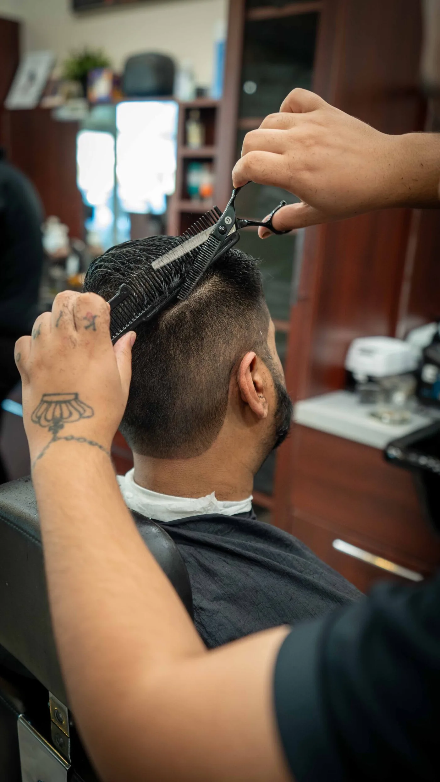 Barber finishing a haircut at CNB Cut
